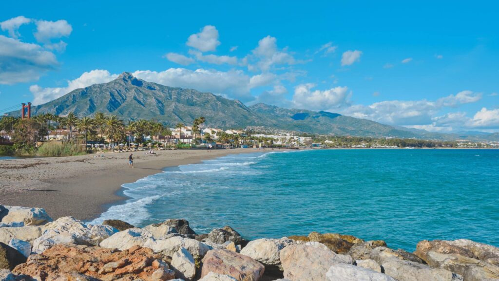 Beautiful scenery of people by the sand in Marbella, Spain