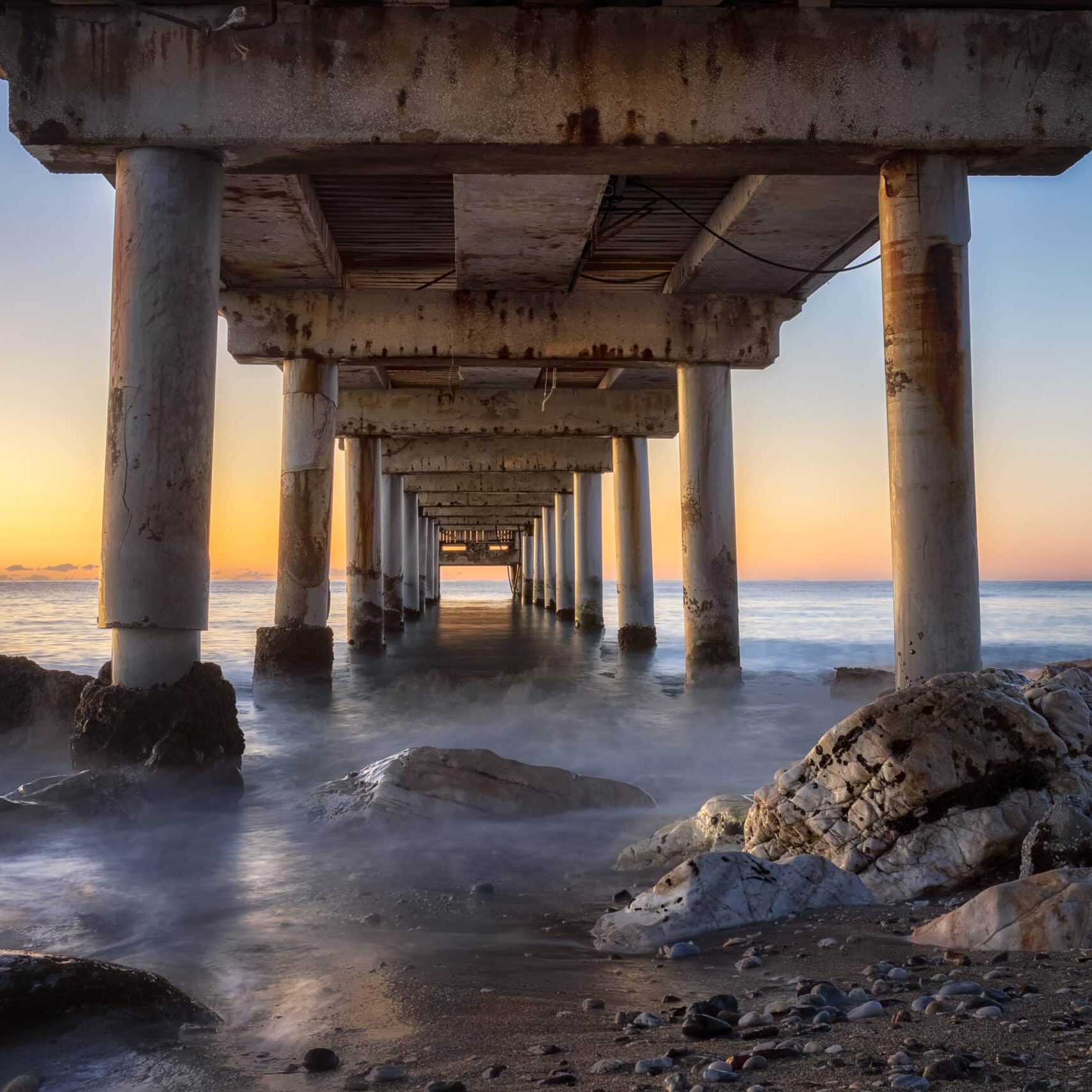 Low angle shot of a pier in Marbella, Spain during sunrise