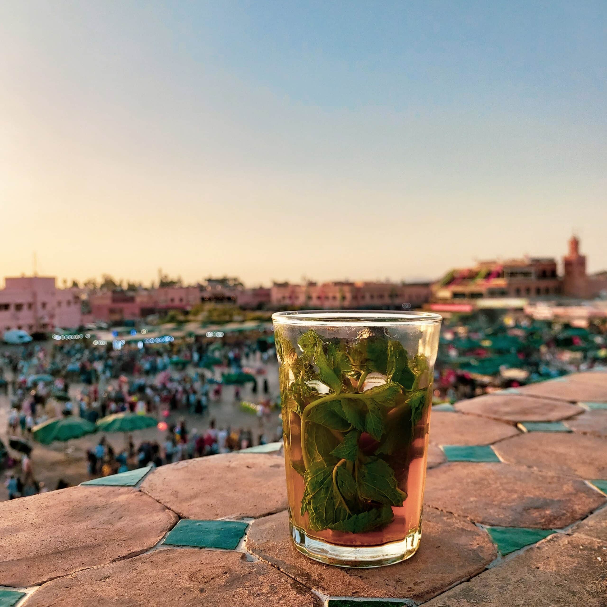 A glass of mint tea on stone tiles in background of beautiful Morocco during Ramadan tea time